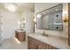 Elegant bathroom boasts double vanities, chandeliers, and sconces for a luxurious and well-lit space at 3323 N 81St St, Mesa, AZ 85207