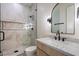 Modern bathroom featuring a glass-enclosed shower, marble tile, and stylish fixtures at 3323 N 81St St, Mesa, AZ 85207