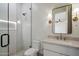 Stylish bathroom featuring a glass shower, sleek fixtures, and a bright vanity area with modern lighting at 3323 N 81St St, Mesa, AZ 85207