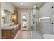 Bright bathroom showcasing a glass-enclosed shower and double sink vanity, for a spa-like experience at 3323 N 81St St, Mesa, AZ 85207