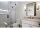 Modern bathroom with glass shower, white vanity, and framed mirror at 3323 N 81St St, Mesa, AZ 85207