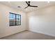 Bright bedroom featuring neutral carpet, large window with mountain views, and ceiling fan at 3323 N 81St St, Mesa, AZ 85207