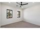 Minimalist bedroom featuring neutral carpet, ample natural light, and black framed windows at 3323 N 81St St, Mesa, AZ 85207