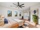Cozy bedroom featuring hardwood floors, three windows, and a mini bar area for entertaining at 3323 N 81St St, Mesa, AZ 85207