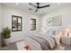 Light-filled bedroom with neutral decor, modern fan, and large windows overlooking the neighborhood at 3323 N 81St St, Mesa, AZ 85207