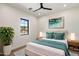 Comfortable bedroom with a soft rug, stylish wall art, and natural light from a window at 3323 N 81St St, Mesa, AZ 85207