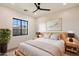 Comfortable bedroom with a view featuring a plush rug, and a wooden bed frame at 3323 N 81St St, Mesa, AZ 85207