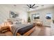 Bright bedroom boasts wood floors, a geometric accent wall, and an oversized window with mountain views at 3323 N 81St St, Mesa, AZ 85207