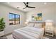 Inviting bedroom with a plush bed, modern nightstands, and a large window showcasing desert views at 3323 N 81St St, Mesa, AZ 85207