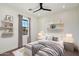 Cozy bedroom featuring a comfortable bed, shelves, and a window with natural light at 3323 N 81St St, Mesa, AZ 85207