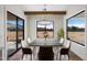 Bright dining room features a modern chandelier, concrete table and large windows with expansive views at 3323 N 81St St, Mesa, AZ 85207