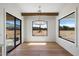 Bright dining room offers beam ceiling, modern light fixture, and serene backyard views at 3323 N 81St St, Mesa, AZ 85207