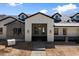 Inviting front entry with a covered porch, brick pavers, and stylish exterior lighting at 3323 N 81St St, Mesa, AZ 85207