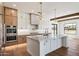 Modern kitchen with quartz countertops, designer lighting, stainless steel appliances, and island at 3323 N 81St St, Mesa, AZ 85207