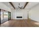 Spacious living room with an electric fireplace, wooden beams, and access to the backyard at 3323 N 81St St, Mesa, AZ 85207