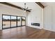 Bright living room featuring wood floors, decorative fireplace, beam ceiling, and sliding glass doors at 3323 N 81St St, Mesa, AZ 85207