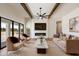 Cozy living room with modern fireplace, ceiling fan, hardwood floors and sliding glass doors with desert view at 3323 N 81St St, Mesa, AZ 85207