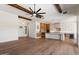 Open-concept living space features wood floors, beam ceiling, and a seamless flow to the modern kitchen at 3323 N 81St St, Mesa, AZ 85207