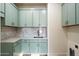 Light and airy mud room with blue cabinets, marble counter tops and backsplash, and stainless steel sink at 3323 N 81St St, Mesa, AZ 85207