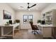 Bright home office with hardwood floors, modern desks, and natural light from two windows at 3323 N 81St St, Mesa, AZ 85207