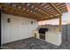 Outdoor kitchen with a grill, a sink, and a granite countertop, perfect for entertaining at 3323 N 81St St, Mesa, AZ 85207