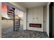 Covered patio with gray pavers, a spiral staircase, and a built-in fireplace at 3323 N 81St St, Mesa, AZ 85207