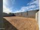 Expansive dirt backyard with block wall, perfect for creating a private outdoor oasis at 4151 W Lisa Ln, San Tan Valley, AZ 85144