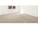 Bedroom boasting neutral carpeting, a window, and bright white walls at 4151 W Lisa Ln, San Tan Valley, AZ 85144