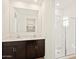 Modern bathroom featuring a dual sink vanity with dark cabinets and a glass enclosed shower at 4182 W Lisa Ln, San Tan Valley, AZ 85144