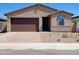 Charming single-story home with a brown garage door, desert landscaping, and a welcoming front entrance at 4182 W Lisa Ln, San Tan Valley, AZ 85144