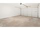 Spacious two-car garage with concrete floors and a white garage door at 4182 W Lisa Ln, San Tan Valley, AZ 85144
