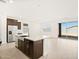 Bright kitchen with island, stainless steel appliances, and access to the backyard at 4182 W Lisa Ln, San Tan Valley, AZ 85144