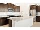 Contemporary kitchen showcasing granite countertops, stainless steel appliances, and tile flooring at 4182 W Lisa Ln, San Tan Valley, AZ 85144