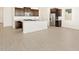 Open-concept kitchen boasts an island, tile flooring, and stainless steel appliances at 4182 W Lisa Ln, San Tan Valley, AZ 85144