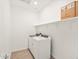 Functional laundry room with washer, dryer, and open shelving for storage at 4182 W Lisa Ln, San Tan Valley, AZ 85144