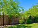 Lush backyard featuring green grass, vibrant trees, and a serene garden landscape against a clear blue sky at 4712 E Amberwood Dr, Phoenix, AZ 85048