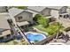 Aerial view features a private backyard with a pool, trampoline, and lush landscaping at 4712 E Amberwood Dr, Phoenix, AZ 85048