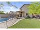 A backyard is complete with a pool, lush green turf, and an outdoor seating area at 4712 E Amberwood Dr, Phoenix, AZ 85048