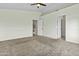 Spacious bedroom features a ceiling fan, neutral walls, and plush carpeting for a cozy atmosphere at 4712 E Amberwood Dr, Phoenix, AZ 85048