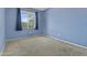 Cozy bedroom featuring neutral carpet, blue painted walls and a sunlit window at 4712 E Amberwood Dr, Phoenix, AZ 85048
