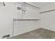 Spacious walk-in closet with white walls and shelving units for efficient storage solutions at 4712 E Amberwood Dr, Phoenix, AZ 85048