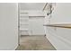 Walk-in closet features white walls, carpeted flooring and installed shelving and hanging storage at 4712 E Amberwood Dr, Phoenix, AZ 85048