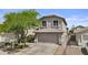 Charming two-story home featuring a spacious garage and mature landscaping with a lush tree at 4712 E Amberwood Dr, Phoenix, AZ 85048