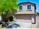 Charming two-story home boasts a neutral facade, two-car garage, and well-maintained landscaping at 4712 E Amberwood Dr, Phoenix, AZ 85048