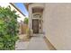 A home's covered front entrance features a decorative door, potted plants, and secure ADT system at 4712 E Amberwood Dr, Phoenix, AZ 85048