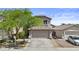 Inviting two-story home with a well-maintained front yard, mature landscaping, and neutral color palette at 4712 E Amberwood Dr, Phoenix, AZ 85048