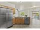 Stylish kitchen with stainless steel appliances, light wood cabinets, and convenient access to the backyard pool at 4712 E Amberwood Dr, Phoenix, AZ 85048