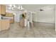 Bright open concept kitchen and living area with tile flooring, stainless steel appliances and wooden cabinets at 4712 E Amberwood Dr, Phoenix, AZ 85048
