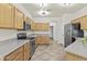 Well-lit kitchen with stainless steel appliances, ample cabinetry, and tile flooring for a modern touch at 4712 E Amberwood Dr, Phoenix, AZ 85048