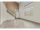 Bright and airy entryway with high ceilings, staircase, large windows, and tile flooring at 4712 E Amberwood Dr, Phoenix, AZ 85048
